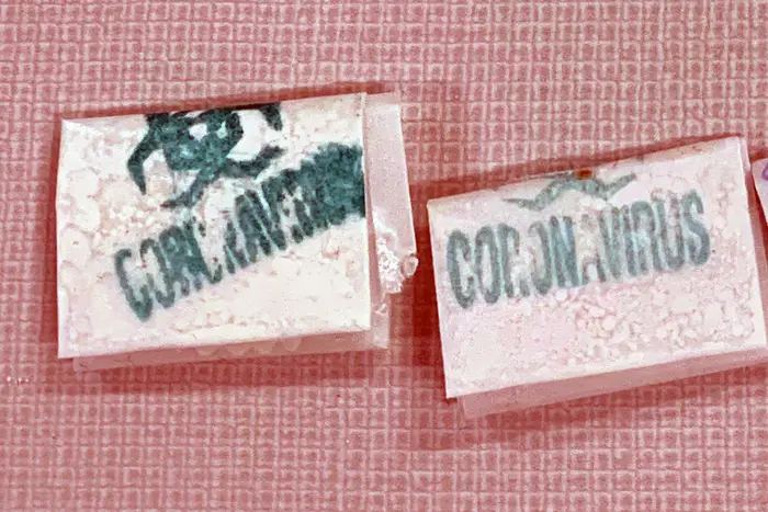 Drug packages stamped with "Coronavirus" and a hazard symbol